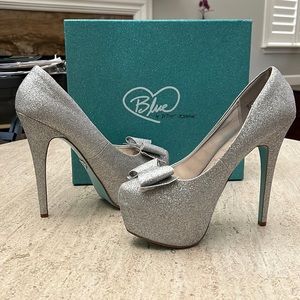 Betsey Johnson silver glitter platform shoes.